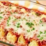 Homemade four cheese manicotti garnished with fresh parsley.