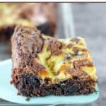 A homemade Oreo brownie on a spatula over the pan of brownies.
