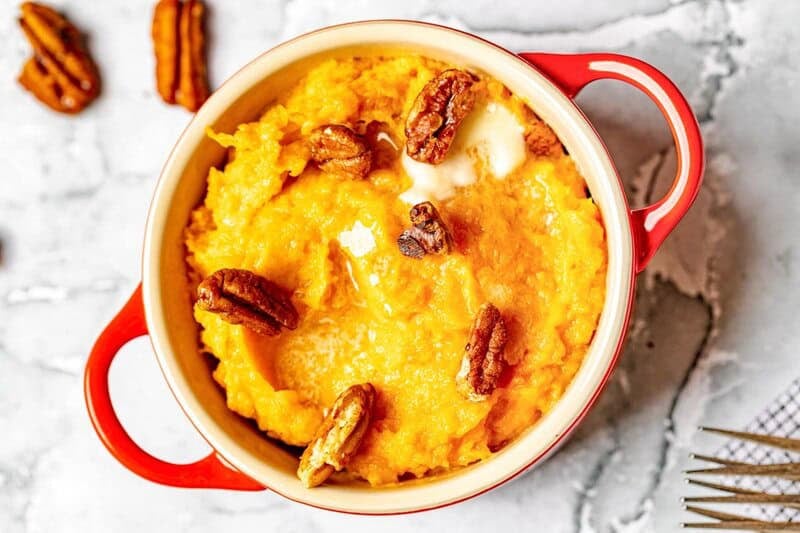 A bowl of copycat Red Lobster whipped sweet potatoes with honey roasted pecans.