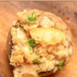 Ritz cracker stuffed mushroom garnished with parsley on a platter.