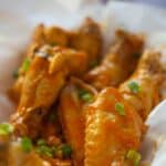 Air-fried garlic buffalo chicken wings in a serving basket.