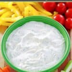 Homemade dill dip served with peppers, cherry tomatoes, carrots, and celery.