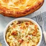 A freshly baked chicken pot pie with veggies and buttery crust on a table.