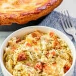 Creamy pot with with chicken, vegetables, parmesan cheese sauce, and flaky crust.