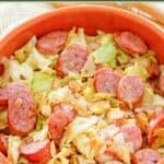 Cabbage fried with sausage and bacon served in a large bowl.