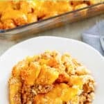 A serving of hamburger meat, tater tot, and cheese casserole on a plate.