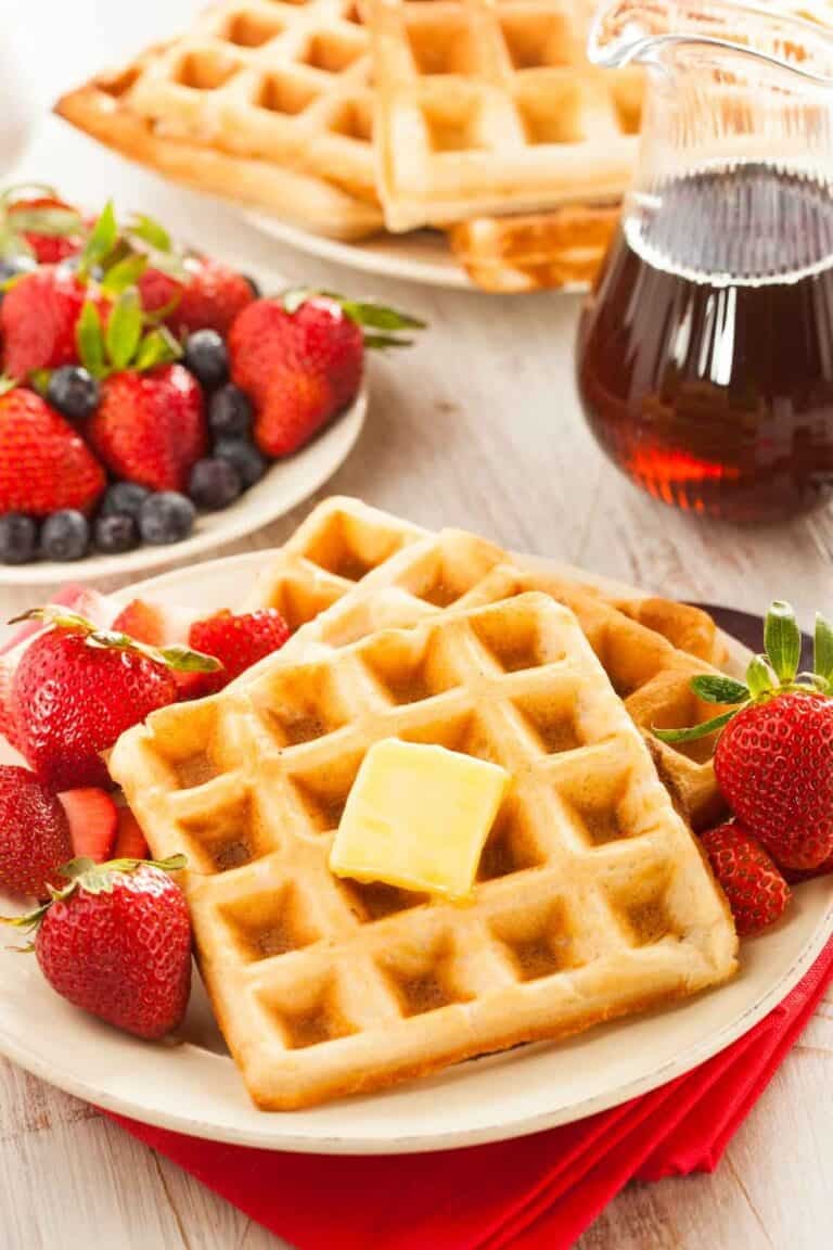 Classic homemade waffles served with syrup and berries.
