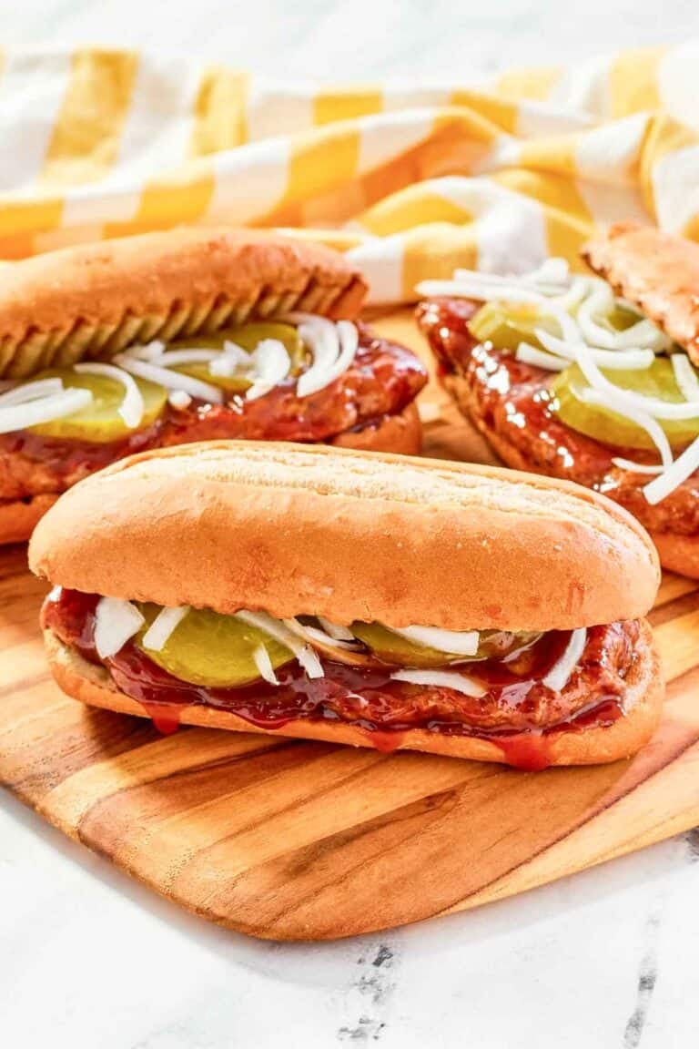 Copycat McDonald's McRib sandwiches on a wood platter.