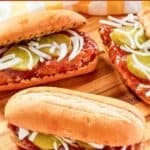 Three homemade McDonald's McRib sandwiches on a wood board.