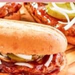 Homemade McDonald's McRib sandwich on a wood board.