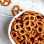 Homemade ranch pretzels in a bowl and beside it.