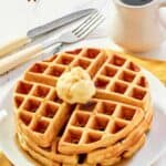 Homemade waffles served with butter and syrup.