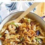 Cajun shrimp, chicken, and sausage alfredo pasta in a skillet.