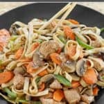 Homemade chicken le mein stir fry served on a plate.