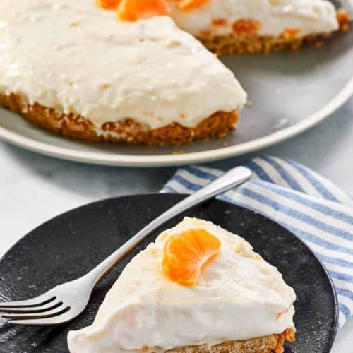 Creamy cheesecake made with mandarin oranges and topped with orange slices.