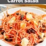 A plate of Luby's shredded carrot salad with pineapple and raisins on a plate.