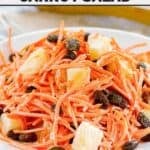 A plate of copycat Luby's shredded carrot salad with raisins and pineapple.