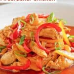 A bowl of chicken and peppers stir-fried with firecracker sauce.