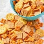 A mix of ranch seasoned crackers spread out on parchment paper.