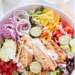 Homemade chicken fajita salad with creamy salsa verde dressing drizzled on top.