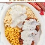 Southern buttermilk country fried steak, white gravy, mashed potatoes, and corn.