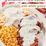 Chicken fried steak and mashed potatoes topped with white gravy.