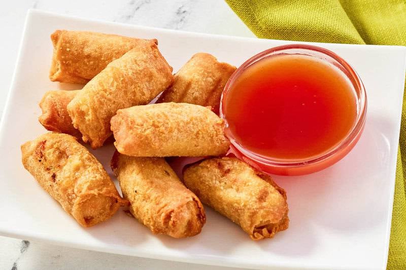 Egg rolls served with a classic Chinese red sauce.