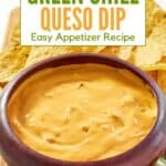 A bowl of creamy green chile queso dip served with tortilla chips.
