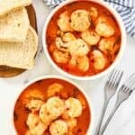 Large shrimp served in a rich and butter tomato herb broth along with bread.