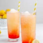 Copycat McDonald's frozen strawberry lemonade served with straws in tall glasses.