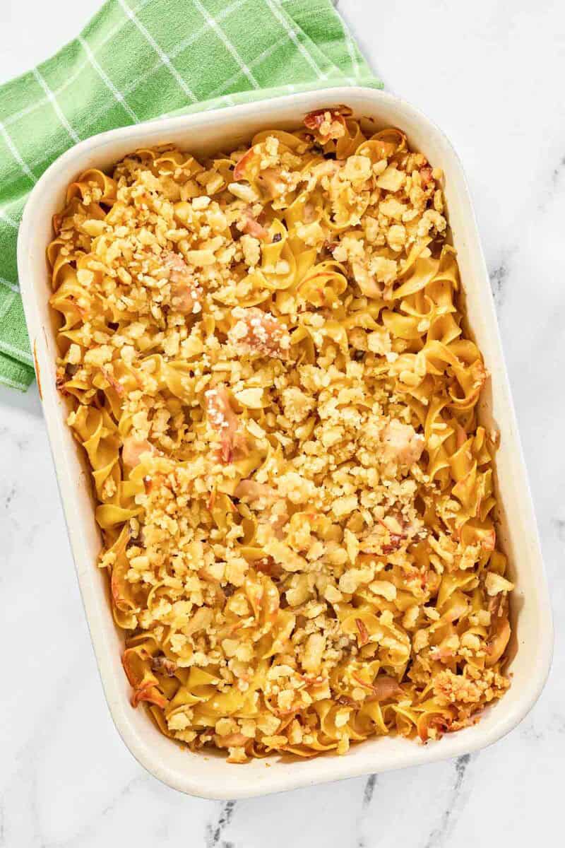 A baked casserole with tuna, mushrooms, and noodles topped with crispy buttery crackers.