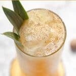A homemade Soggy Dollar Bar painkiller cocktail garnished with nutmeg.