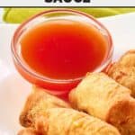 Chinese red sweet and sour sauce in a small bowl next to egg rolls.