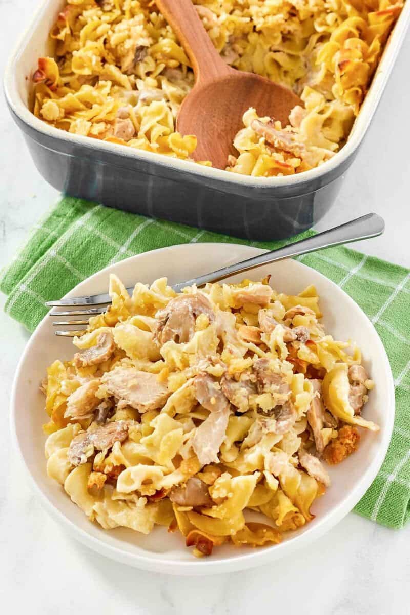 A casserole with tuna, noodles, and cracker topping baked and served.