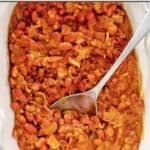 BBQ baked beans with bacon in a ceramic serving dish.