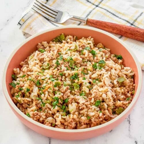 Cajun seasoned ground beef and rice dish on a marble surface.