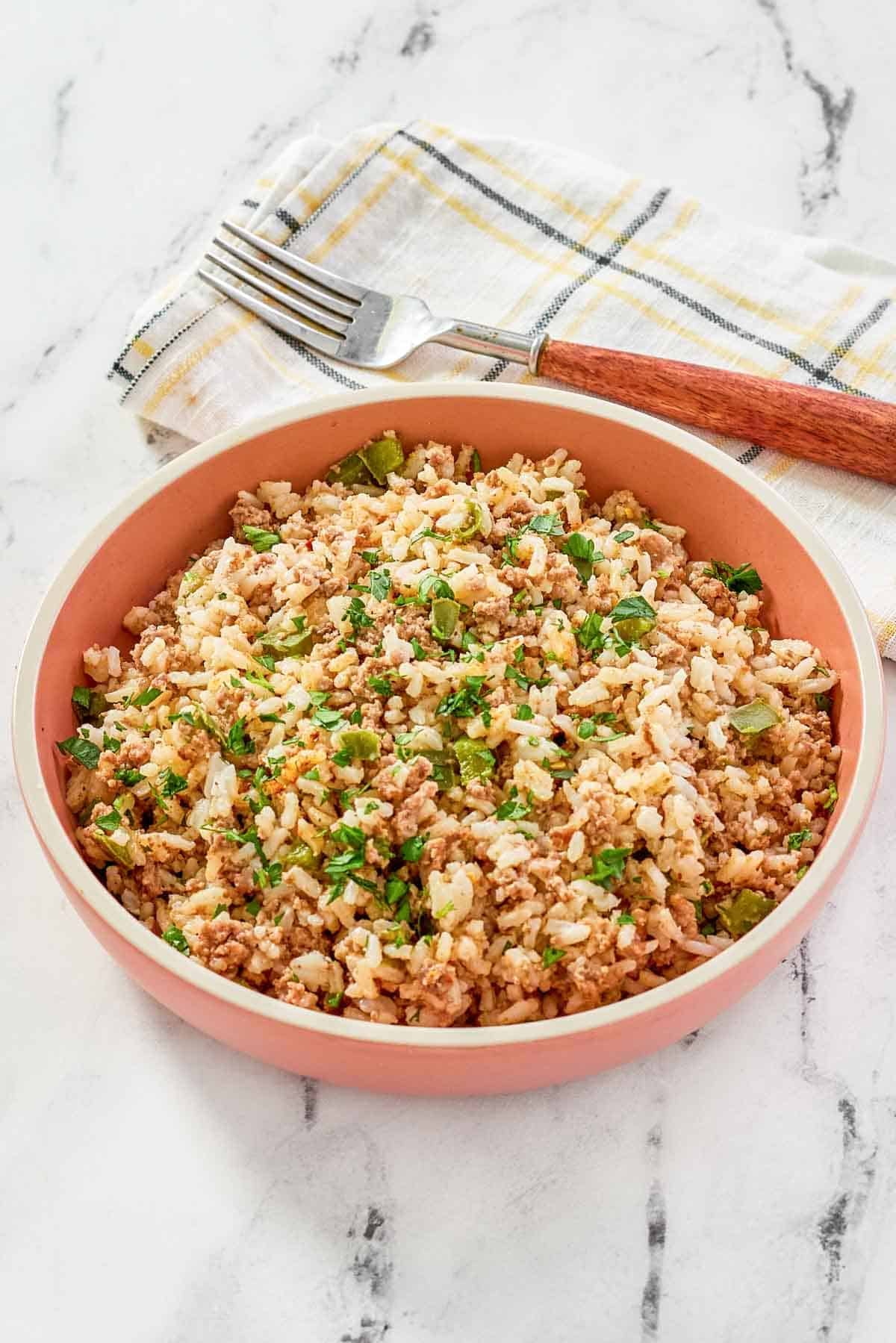 Cajun seasoned ground beef and rice dish on a marble surface.