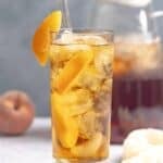Copycat Olive Garden peach iced tea in a glass and a pitcher.
