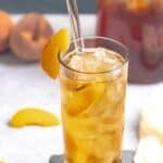 A glass of copycat Olive Garden peach iced tea on a coaster.