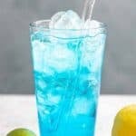 Copycat Sonic ocean water drink on a coaster, a lime, and a lemon.