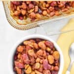 Baked beans quintet in a casserole dish and a serving in a bowl.