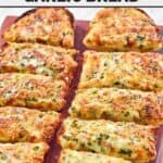 Slices of Black Angus Steakhouse cheesy garlic bread served on a wood board.