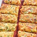 Copycat Black Angus Steakhouse cheesy garlic bread on a wood platter.