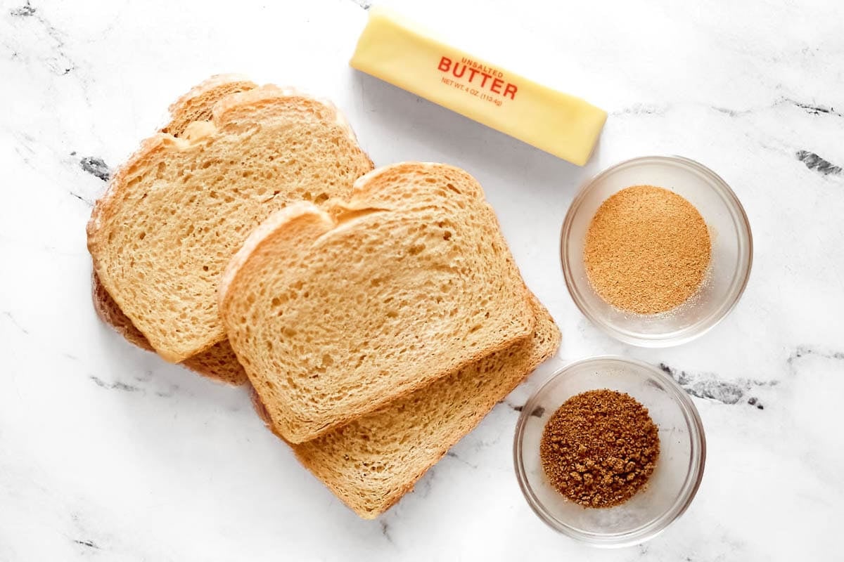 Thick-sliced bread, butter, garlic powder, and seasoned salt.