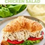 Copycat Chicken Salad Chick Greek Goddess chicken salad with lettuce and tomato on a croissant.