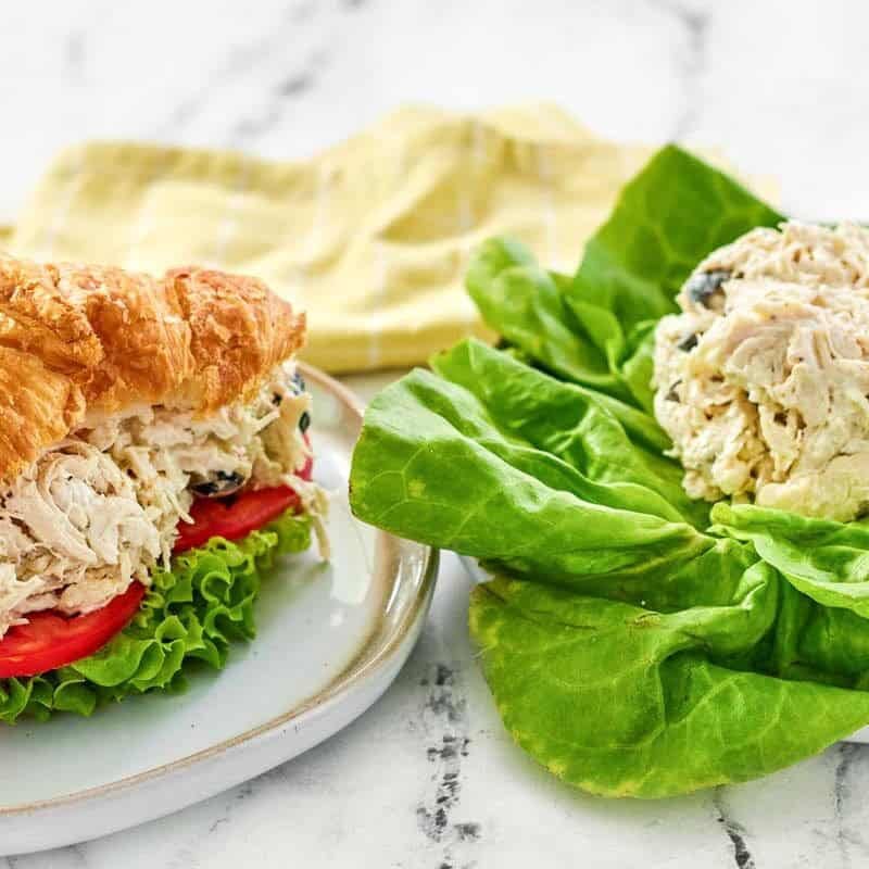 Creamy shredded chicken, olive, and feta salad served on lettuce and in a sandwich.