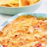 Cheesy chicken Rotel dip and a bowl of tortilla chips.