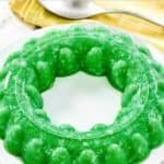 Creamy lime Jell-O salad with cottage cheese and crushed pineapple made in a gelatin mold.