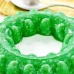 Creamy lime gelatin salad with cottage cheese and pineapple made in a Jell-O mold.