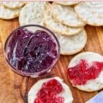 Homemade wine jelly in a small glass cup and spread on top of cream cheese crackers.
